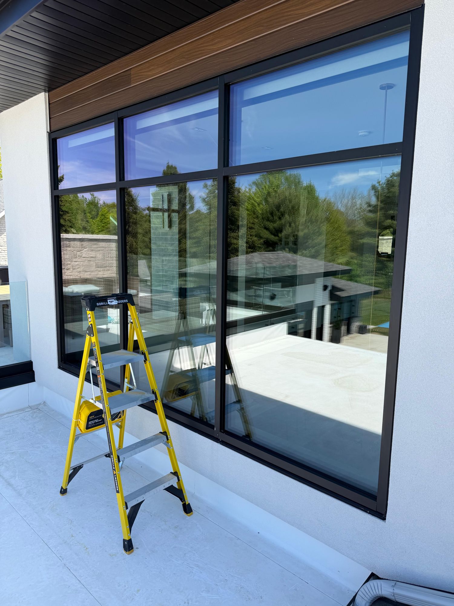 Imperial Cleaning technician squeegeeing a residential window in Sault Ste. Marie